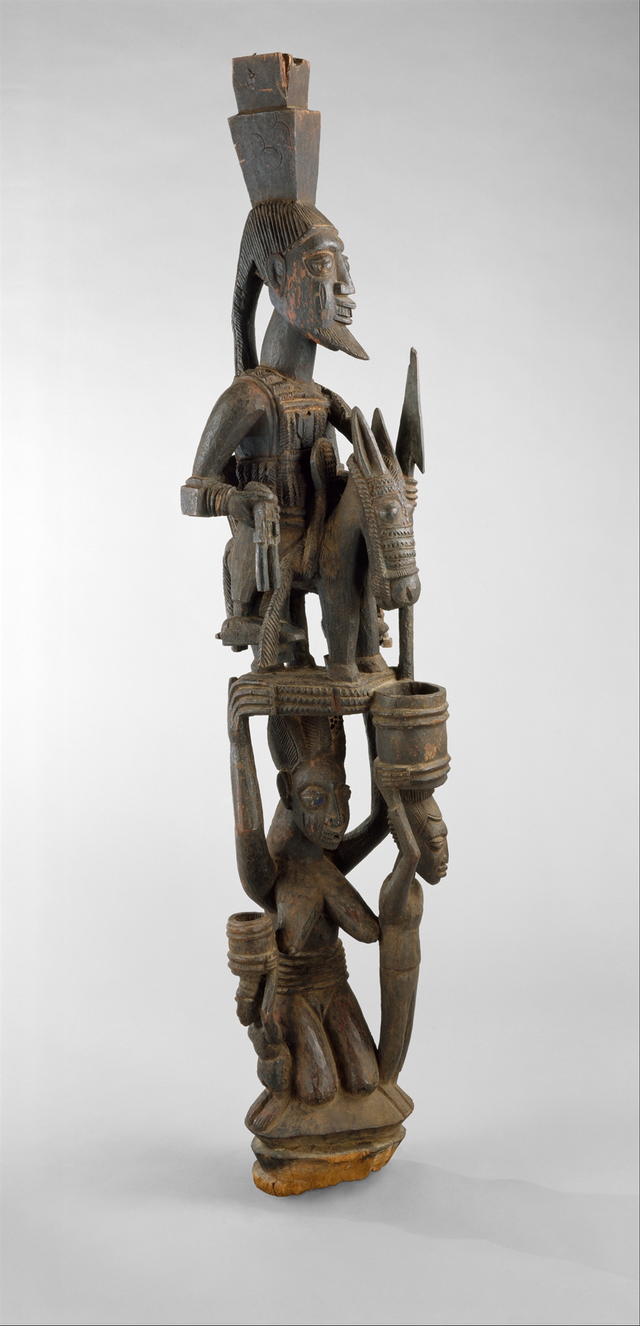 Olowe of Ise, Veranda Post, before 1938 (Yoruba peoples, Nigeria), wood, pigment, 180.3 x 28.6 x 35.6 cm (The Metropolitan Museum of Art, New York City)