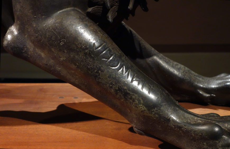 Inscription “tinścvil” on Chimera (detail), Chimera of Arezzo, c. 400 B.C.E., bronze, 129 cm in length (Museo Archeologico Nazionale, Florence; photo: Steven Zucker, CC BY-NC-SA 2.0)