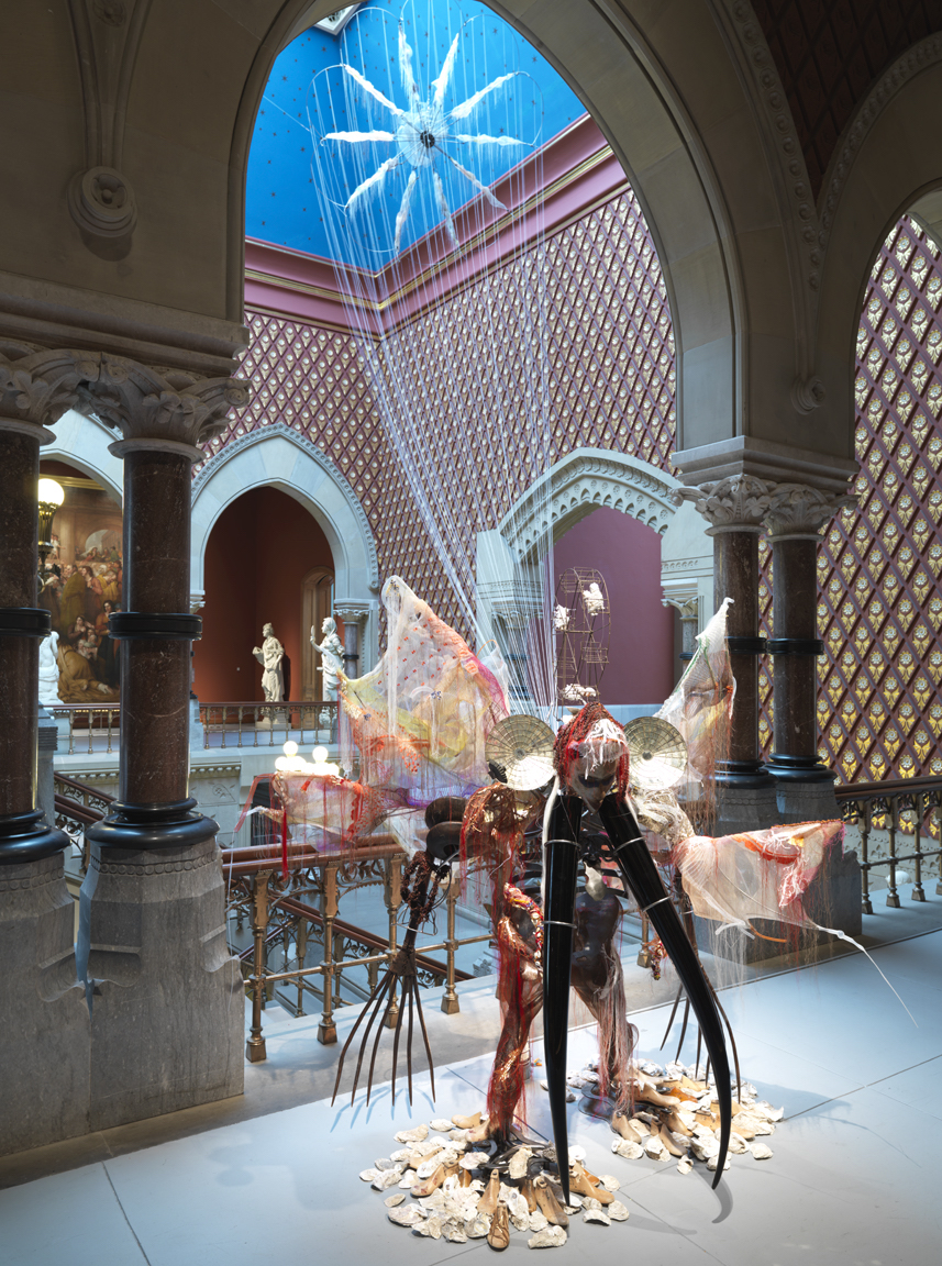 Rina Banerjee, Viola, from New Orleans-ah, 2017, Murano glass horns, Indian rakes, seed beads, steel, Yoruba African mask, oyster shells, cowrie shells, Charlotte dolls, polyester horse hair trim, Korean silks, Indian silks, vintage Kashmir shawls, French wire Ferris wheel, Congolese elbow bangles, colonial mirror sconces, Japanese seed glass beads, sequins, threads, dimensions variable (Pennsylvania Academy of the Fine Arts)