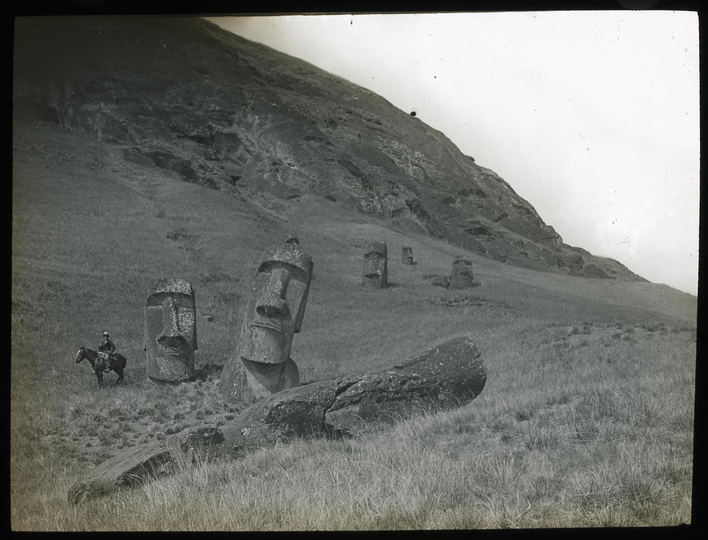 View of the northeast of the exterior slopes of the quarry, with several moai on the slopes, Rapa Nui (Easter Island), Katherine Maria Routledge, c. 1914–15, 8.2 x 8.2 cm, lantern slide (photograph) (© Trustees of the British Museum)