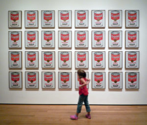 Girl looking at: Andy Warhol, Campbell's Soup Cans, 1962, synthetic polymer on 32 canvases each 20 x 16 inches (The Museum of Modern Art; photo: Steven Zucker, CC BY-NC-SA 2.0)