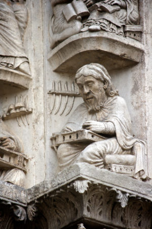 A scribe identified as Priscian or Donatus, part of a series of Liberal Arts and scribes on the archivolt of the right bay, West Portal, Chartres, c.1150 (photo: Nick Thompson, CC BY-NC-SA 2.0)