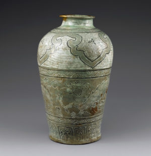 Exemplifying the unique aesthetics of buncheong ware, this jar is decorated with a dynamic design of two dragons, embellished with auxiliary designs of stamped chrysanthemums and a large ruyi motif, and coated with light green translucent glaze. Buncheong Jar with Cloud and Dragon Design, Joseon (15th century), Height: 48.5 cm, National Treasure 259 (National Museum of Korea)