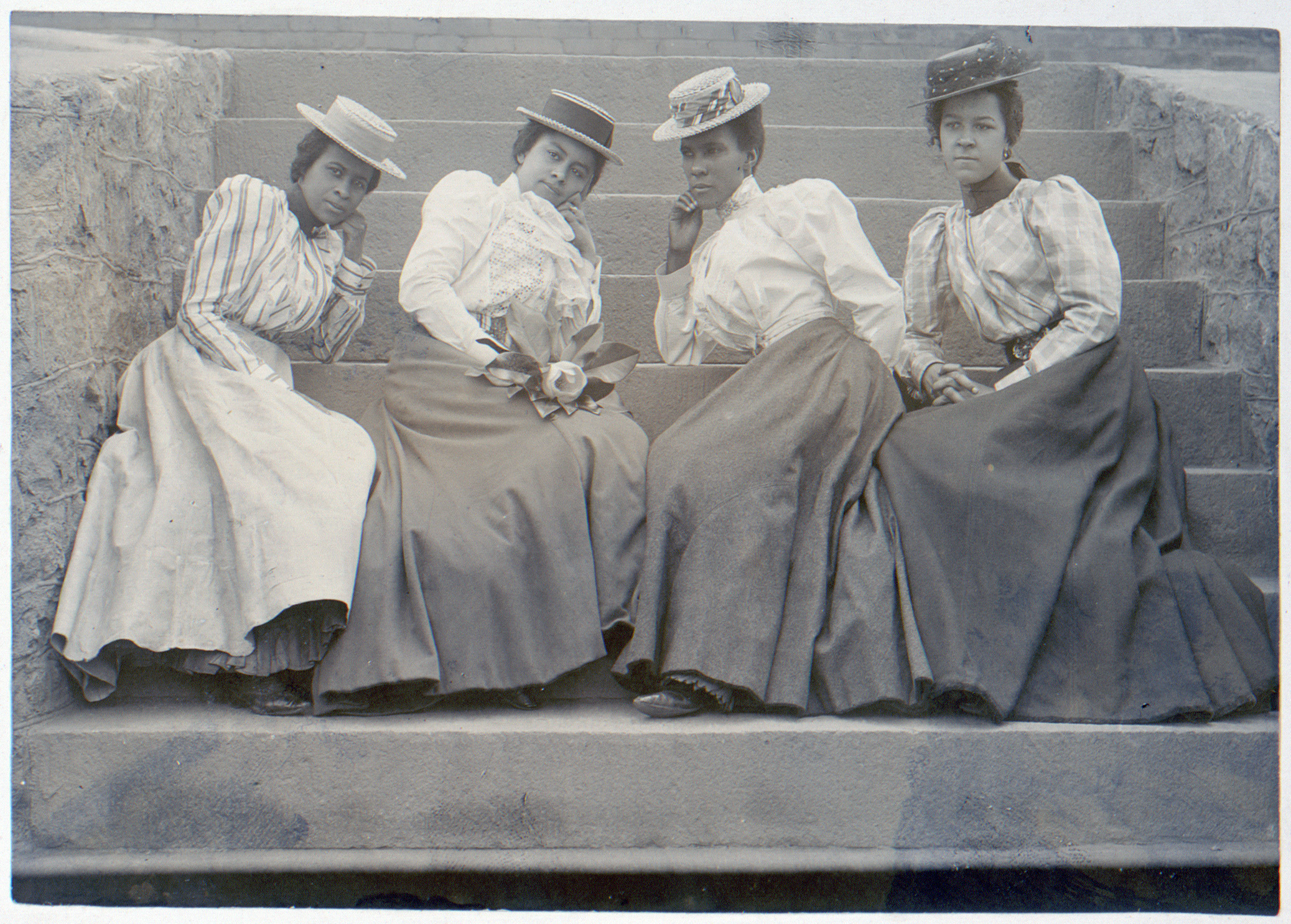 Thomas E. Askew, Four African American women seated on steps of building at Atlanta University, Georgia, 1899 or 1900, matte collodion silver print, photo in album (disbound): Negro life in Georgia, U.S.A., compiled and prepared by W.E.B. Du Bois, v. 4, no. 362 (Library of Congress)