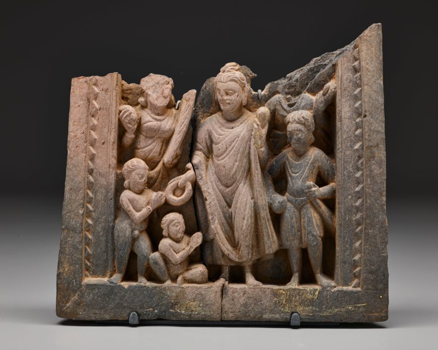 Image of Buddha with attendants from Gandhara, c. 4th century C.E., gray schist, 20.955 x 23.495 x 5.08 cm (Dallas Museum of Art)