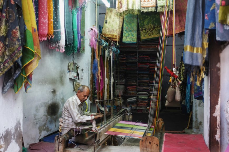 Weaver using a pit loom, India (photo: Zac Davies, CC BY-ND 2.0)