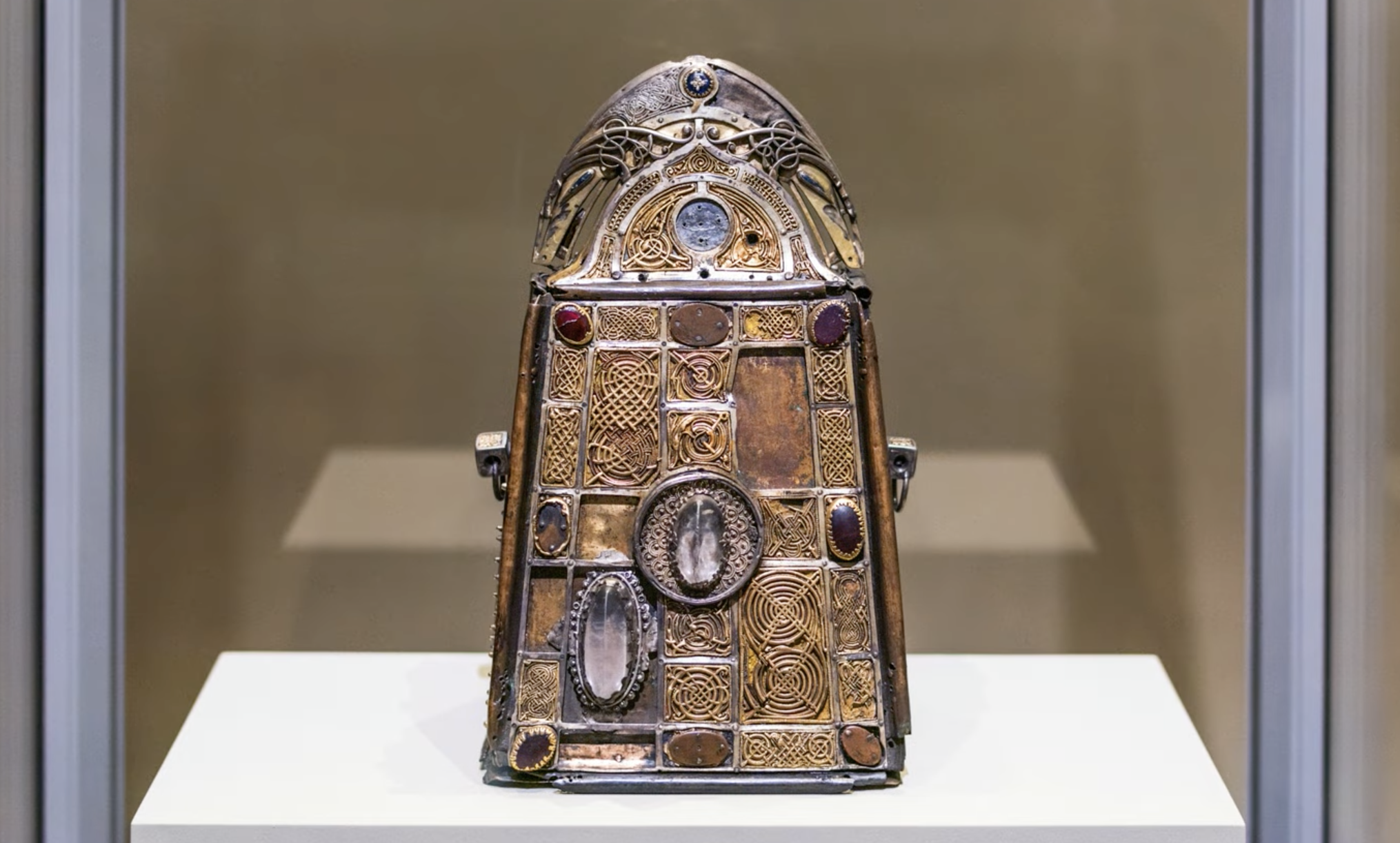 Saint Patrick's Bell and Shrine; bell: 8th–9th century C.E., iron; shrine: c. 1100 C.E., copper-alloy box, silver gilt, gold, silver, gilt-copper, rock crystal, colored stones, 26.7 x 15.5 cm (National Museum of Ireland, Dublin)