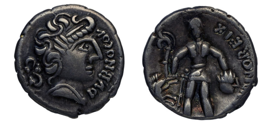 Celtic coin with a head and the name Dubnocou (front) and a warrior and the name Dubnoreix (back), 50s B.C.E., silver, 1.4 cm diameter, minted by the Aeduan people of Bibracte, France (Bibliothèque Nationale, Cabinet des Médailles, Paris). The warrior (right) wears a helmet and armor and has a sword hanging from his right hip. In his right hand, he holds a military standard in the shape of a boar and an animal-headed trumpet called a carnyx. In his left hand, he holds the severed head of an enemy. The accompanying letters give an alternative spelling of Dumnorix, a well-known Aeduan leader mentioned in Julius Caesar, Gallic War, 1.3, 1.9, 1.18-20, 5.6-7.