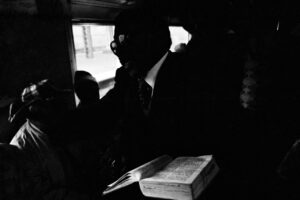 Santu Mofokeng, "The Book, Johannesburg—Soweto Line," from the series Train Churches, 1986, gelatin-silver print, 19 x 28.5 cm (The Walther Collection) © Santu Mofokeng