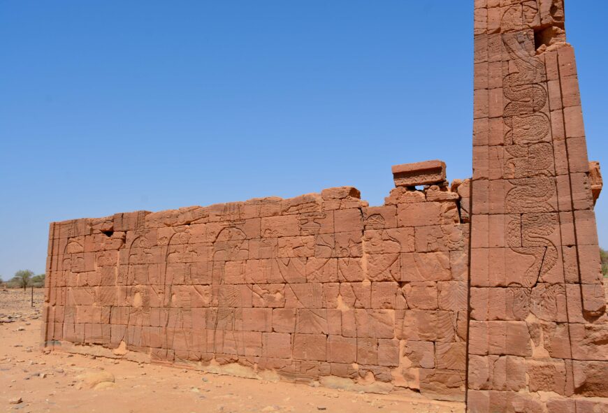 King Natakamani and Queen Amanitore face and worship the lion-headed form of Apedemak and other male gods from the side of the Lion Temple, Naga, Sudan. (Photo: Stuart Tyson Smith, CC BY-SA 4.0)