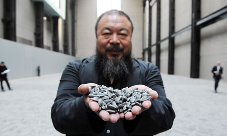 Artist with installation, Ai Weiwei, Kui Hua Zi (Sunflower Seeds), 2010, one hundred million hand painted porcelain seeds (Tate Modern, London) © Ai Weiwei