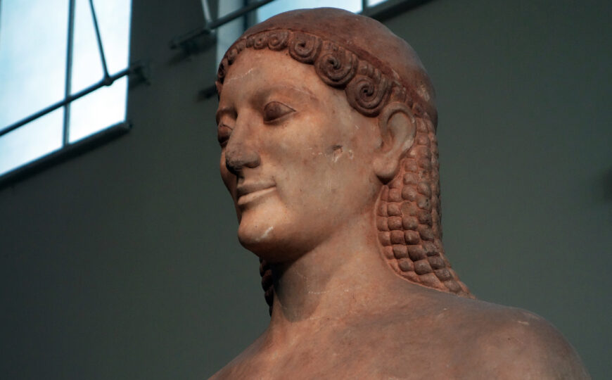 Side view of the kouros’s head (detail), Anavysos Kouros, c. 530 B.C.E., marble, 6 feet 4 inches high (National Archaeological Museum, Athens; photo: Steven Zucker, CC BY-NC-SA 2.0)
