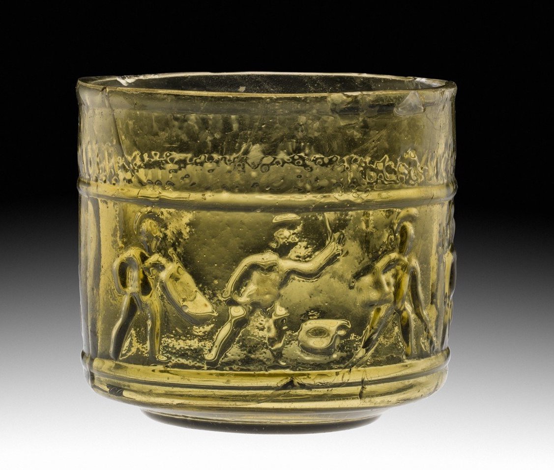 Cup depicting gladiatorial games, c. 50 C.E., mold-blown glass, 7.1 x 7.5 cm (Corning Museum of Glass, New York). Found in Chavagnes, France, in the late 19th century. Gladiators and other athletes were depicted in media ranging from cups, lamps, and knives, to relief sculptures, floor mosaics, and wall paintings.