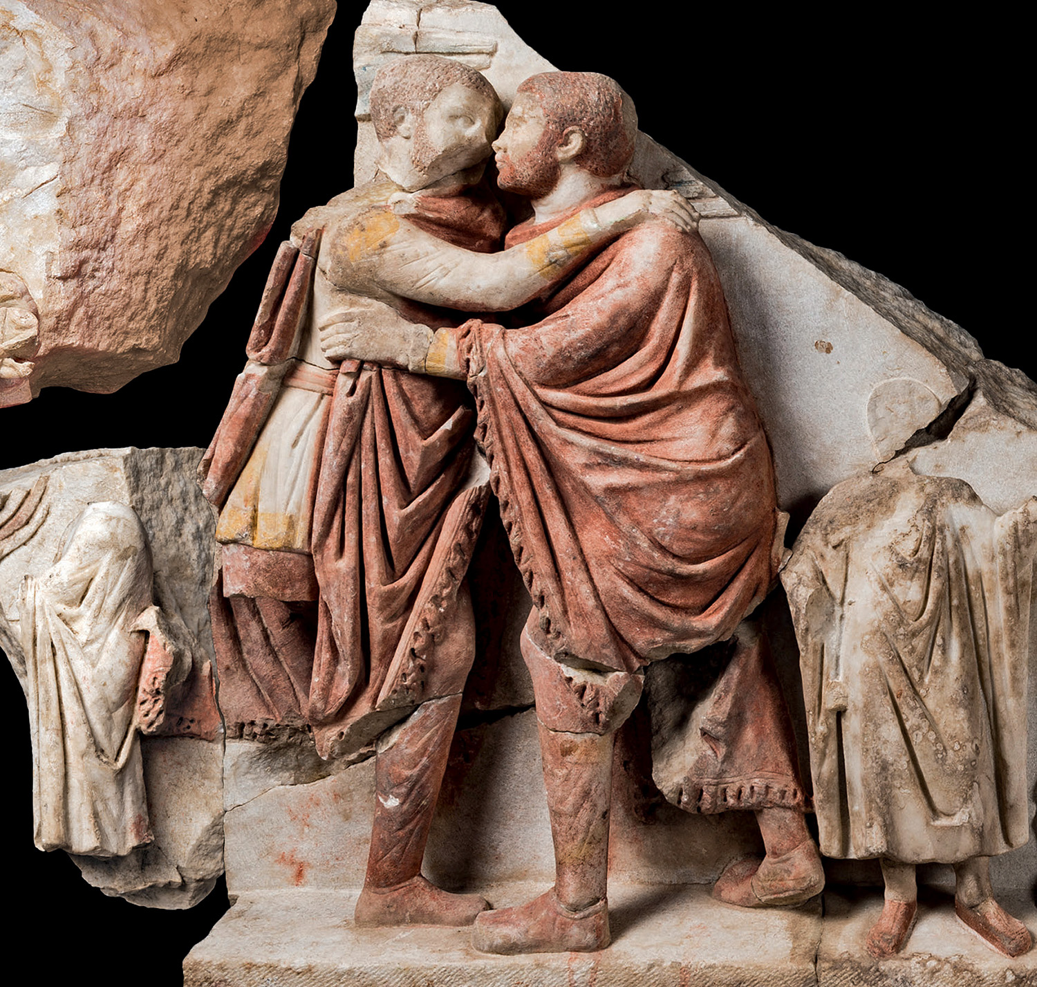 Part of an interior frieze depicting the elder tetrarch Diocletian and the younger tetrarch Maximian embracing in cooperation at the end of a procession, c. 300 C.E., painted marble, 1 m high (Kocaeli Museum, İzmit). Found in excavations of a ceremonial building at İzmit (Nicomedia, Türkeyi) in 2001/2009