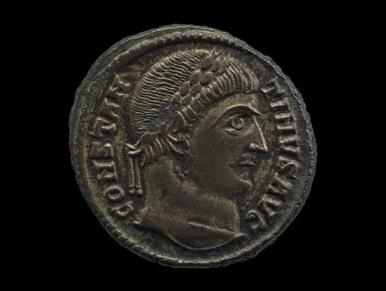 Coin depicting Constantine I,  327–328 C.E., bronze, 2 cm diameter (© The Trustees of the British Museum, London). The coin was minted in Alexandria, Egypt, and excavated in 1914 at Antinoöpolis, Egypt, the city that Hadrian established in honor of his deceased lover Antinous. The double painted portrait at the beginning of the essay was also excavated at Antinoöpolis
