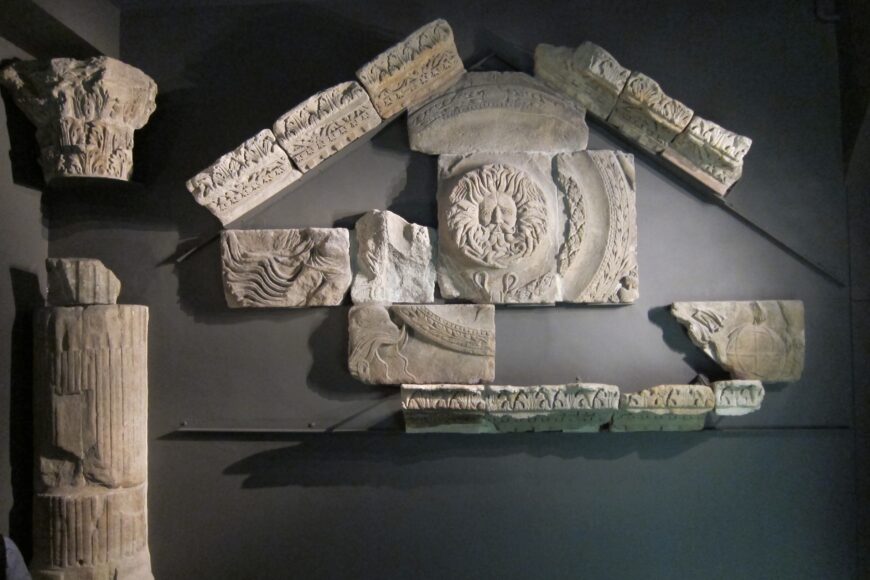 From the temple, fragments of a column and pedimental sculptures now reconstructed in the Roman Baths Museum (Roman Baths Museum, Bath; photo: Kimberly Cassibry, CC BY-NC-SA 4.0)