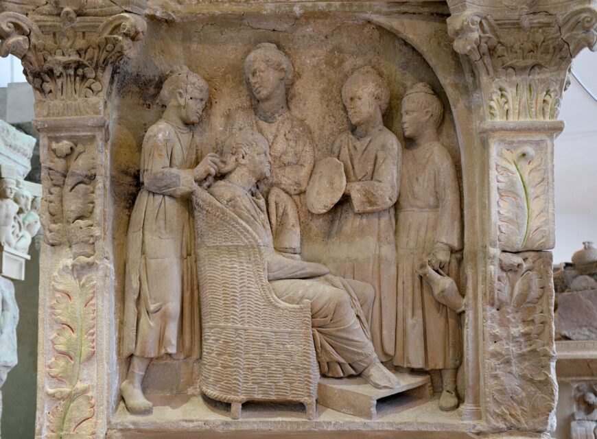 Funerary relief depicting a woman's hair being dressed by enslaved women, c. 220 C.E. (Neumagen, Germany) (Rheinisches Landesmuseum Trier; photo: Carole Raddato, CC BY-SA 2.0)