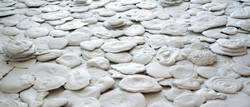 Barbara Zucker, Mix, Stir, Pour (White Floor Piece), 1972, poured plaster, multiple units, variable dimensions (collection of the artist, © Barbara Zucker, all rights reserved) photographed at the Aldrich Contemporary Art Museum in 2022.