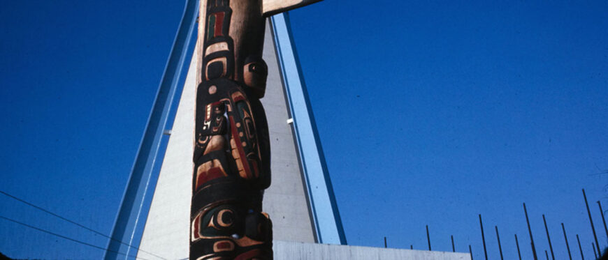 Detail of totem pole by Henry and Tony Hunt and tipi in the background at the Indians of Canada Pavilion, 1967 (Library and Archives Canada / Canadian Corporation for the 1967 World Exhibition)