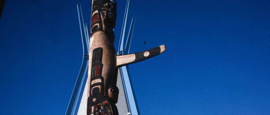 Detail of totem pole by Henry and Tony Hunt and tipi in the background at the Indians of Canada Pavilion, 1967 (Library and Archives Canada / Canadian Corporation for the 1967 World Exhibition)