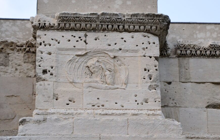 South side of the Arch at Orange showing an unidentified woman on a projecting part of the attic. The holes surrounding the sculpture show where metal attachments were once nailed. Arch at Orange, France, 20s B.C.E., stone, 19.21 x 19.57 x 8.4 m (photo: Marianne Casamance, CC BY-SA 3.0)