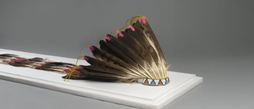 Sioux or Cheyenne Artist, Feathered War Bonnet (Pawhuska, Oklahoma), late 19th-early 20th c., feathers, beads, pigment, hide, dyed horsehair, 174 x 21.5cm (The Brooklyn Museum)