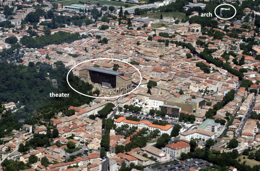 Aerial view of Orange in 2009, with the ancient theater shown in the center of town and the arch shown at the edge of town while under scaffolding for cleaning (photo: Jean-Louis Zimmermann, CC BY-SA 2.0)