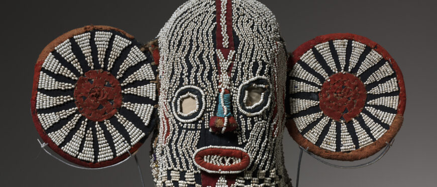 Mask (mbap mteng), early 1900s (Bamileke peoples), cotton, burlap, glass beads, twine, leather, and wood, 139.7 x 50.8 x 19.1 cm (The Cleveland Museum of Art)