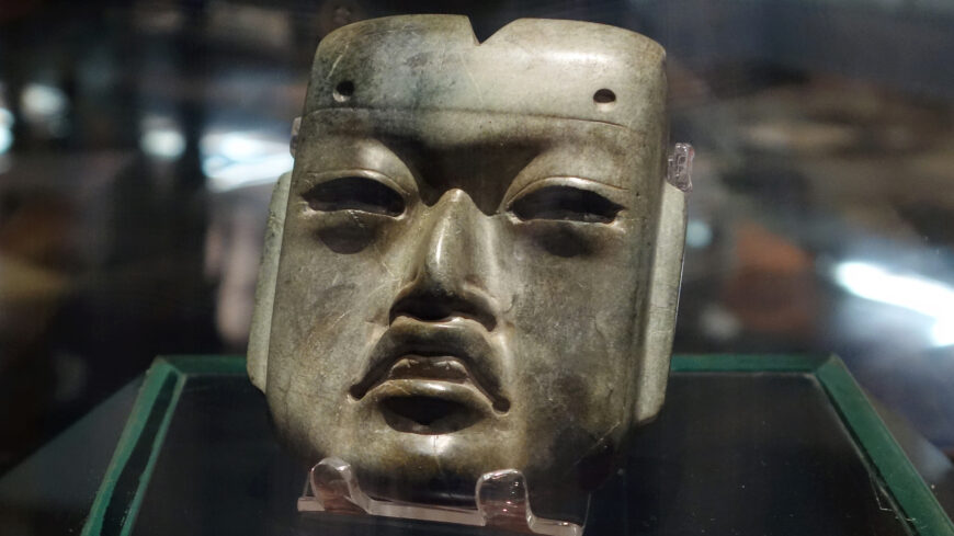 Olmec-style mask, c. 1200–400 B.C.E., found in offering 20 buried c. 1470 C.E. at the Mexica Templo Mayor, jadeite, 4 x 3-3/8 x 1-1/4 inches (Museo del Templo Mayor, Mexico City; photo: Steven Zucker, CC BY-NC-SA 2.0)