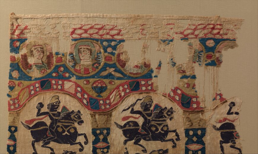 Medallions containing portraits above arched panels with mounted horsemen (detail), Fragment from a Coptic Hanging, 5th century (attributed to Egypt), linen, wool, plain weave and tapestry weave, 104 x 63 cm (The Metropolitan Museum of Art, New York)