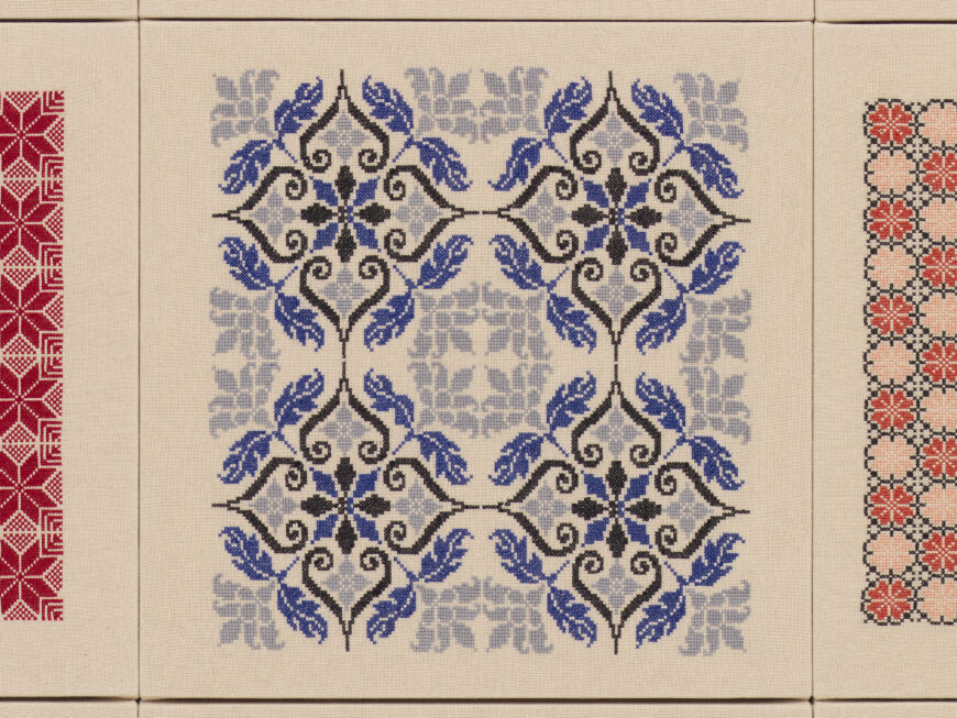 Blue-and-black curvilinear design (center) with Bethlehem Moon and Feather (left) and Damask Rose (right) motifs (detail), Jordan Nassar, A Mountain Looms, 2023, hand-embroidered cotton on cotton, 213.4 x 213.4 x 2.5 cm (Courtesy of Private Collection and Jordan Nassar; photo: Dan Bradica) © Jordan Nassar