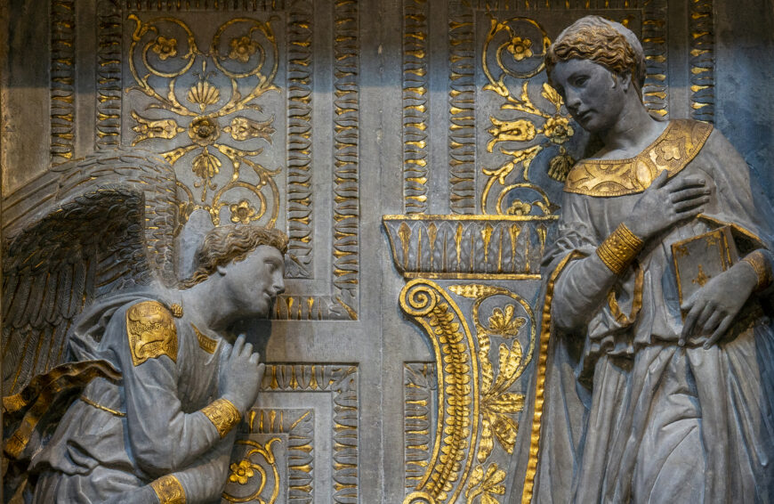 Donatello, Annunciation, 1433–35, pietra serena, gilding; putti made of terracotta and stucco, 420 x 274 x 30 cm, south aisle, Basilica of Santa Croce, Florence; commissioned by Niccolò di Giovanni Cavalcanti, brother-in-law of Lorenzo de' Medici