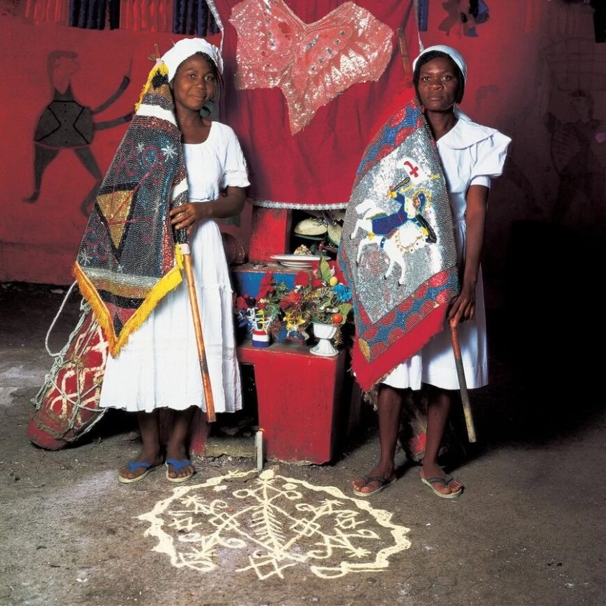 Co-drapeaux (flag bearers). Phyllis Galembo, Rose Anne and Andre Rose Mercilien with Drapo, 1994 © Phyllis Galembo